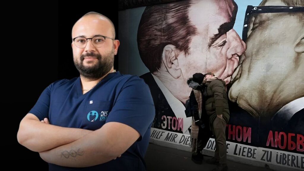 Berlin Duvarı’nın önünde eşini öpen AKP’li isim, ‘incinen’ herkesten özür diledi